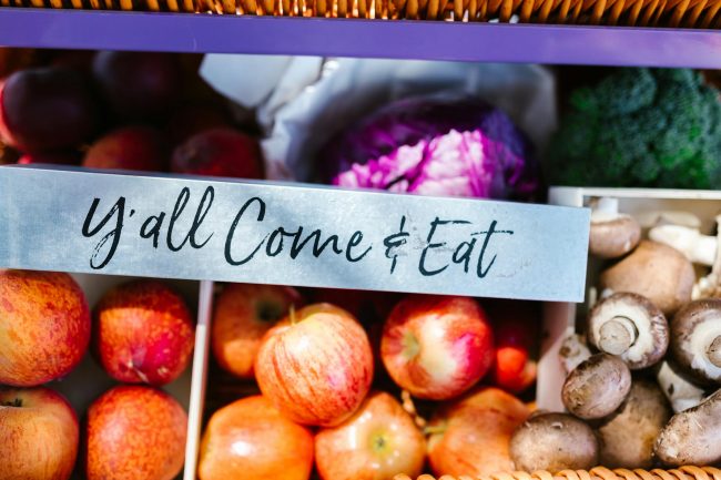 A vibrant display of fresh organic fruits and vegetables at a farmers market.