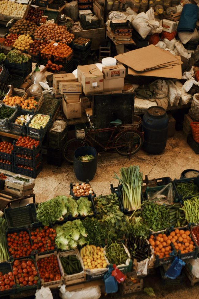 Vibrant market scene with fresh fruits and vegetables, offering a top-down view.